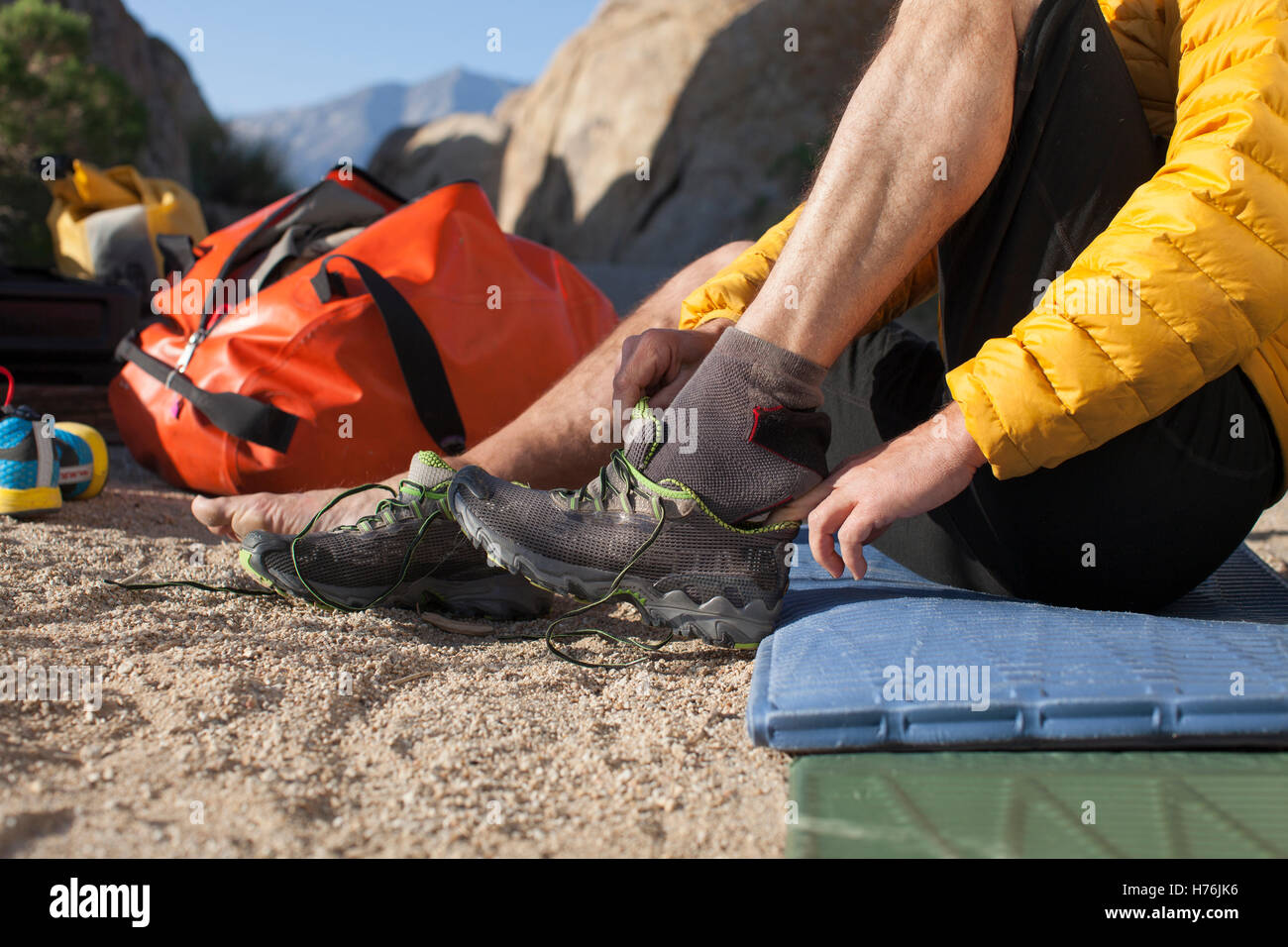Cropped image of a man in camp putting on his shoes to go for a trail run. Stock Photo