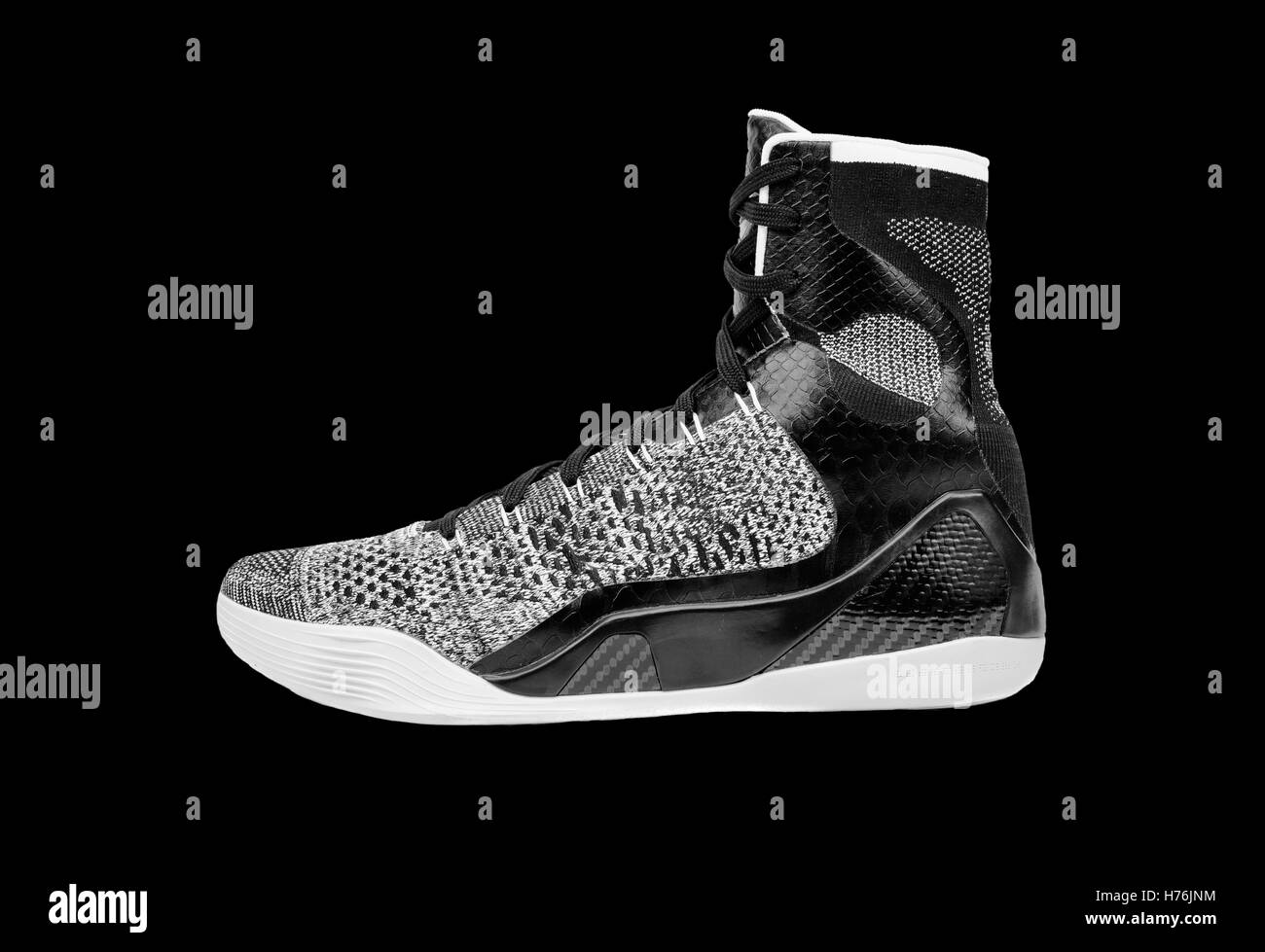 Ultra modern high-top grey and black basketball shoe sneaker, isolated on black Stock Photo
