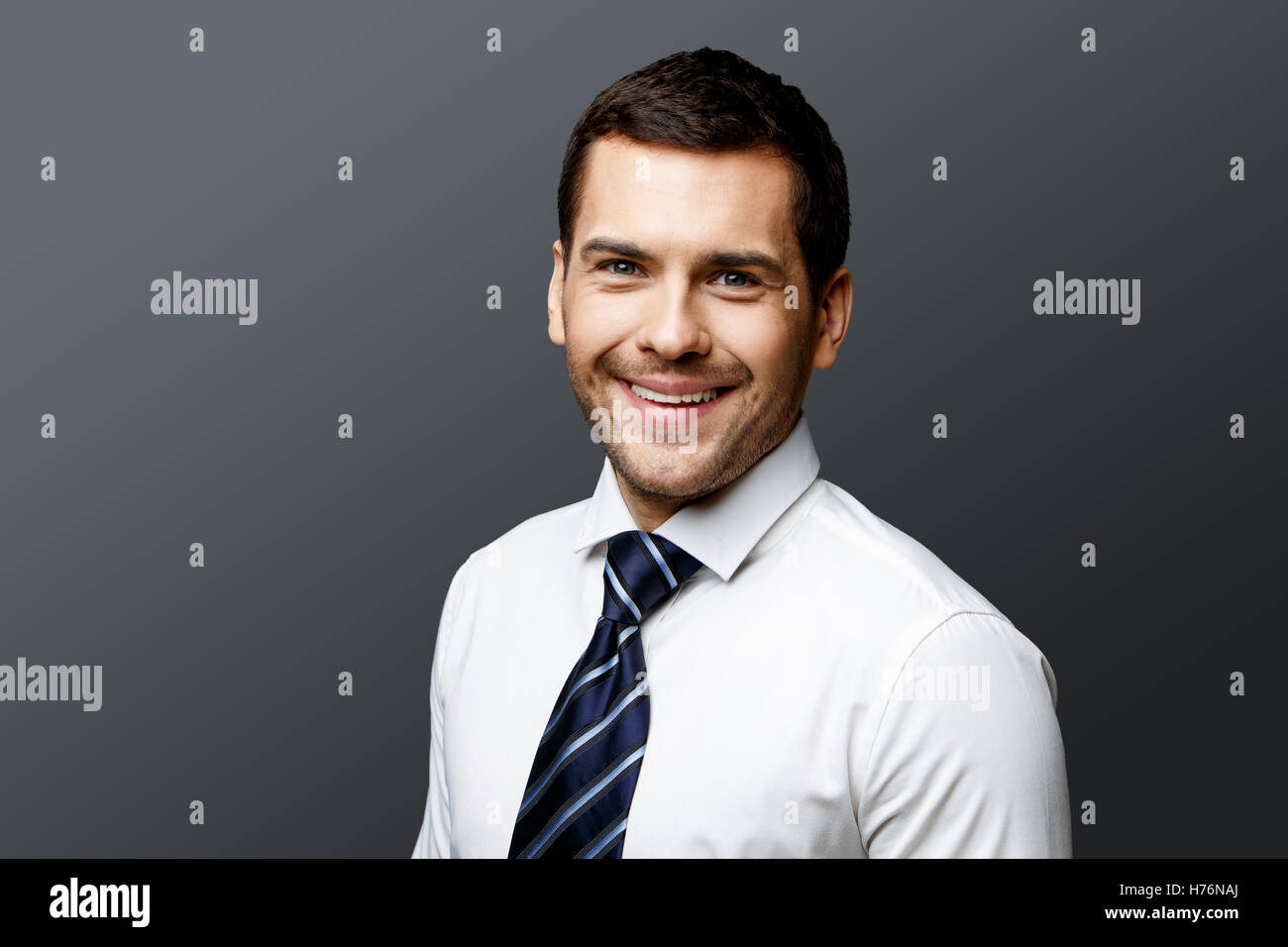 Handsome stylish businessman on grey background Stock Photo - Alamy