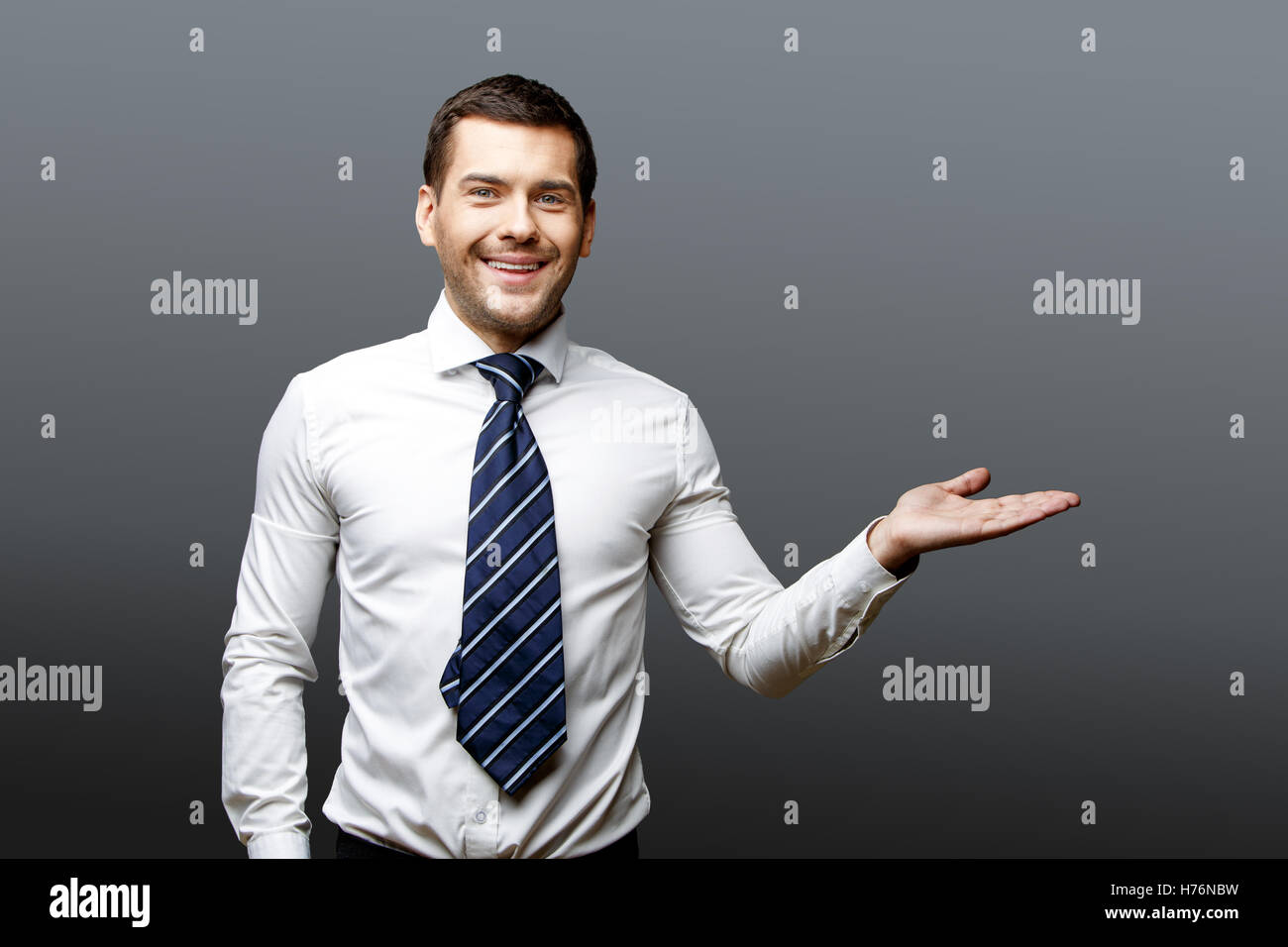 Handsome stylish businessman on grey background Stock Photo - Alamy