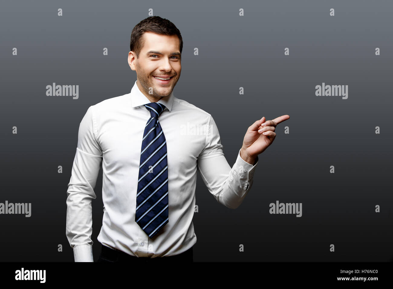Handsome stylish businessman on grey background Stock Photo - Alamy