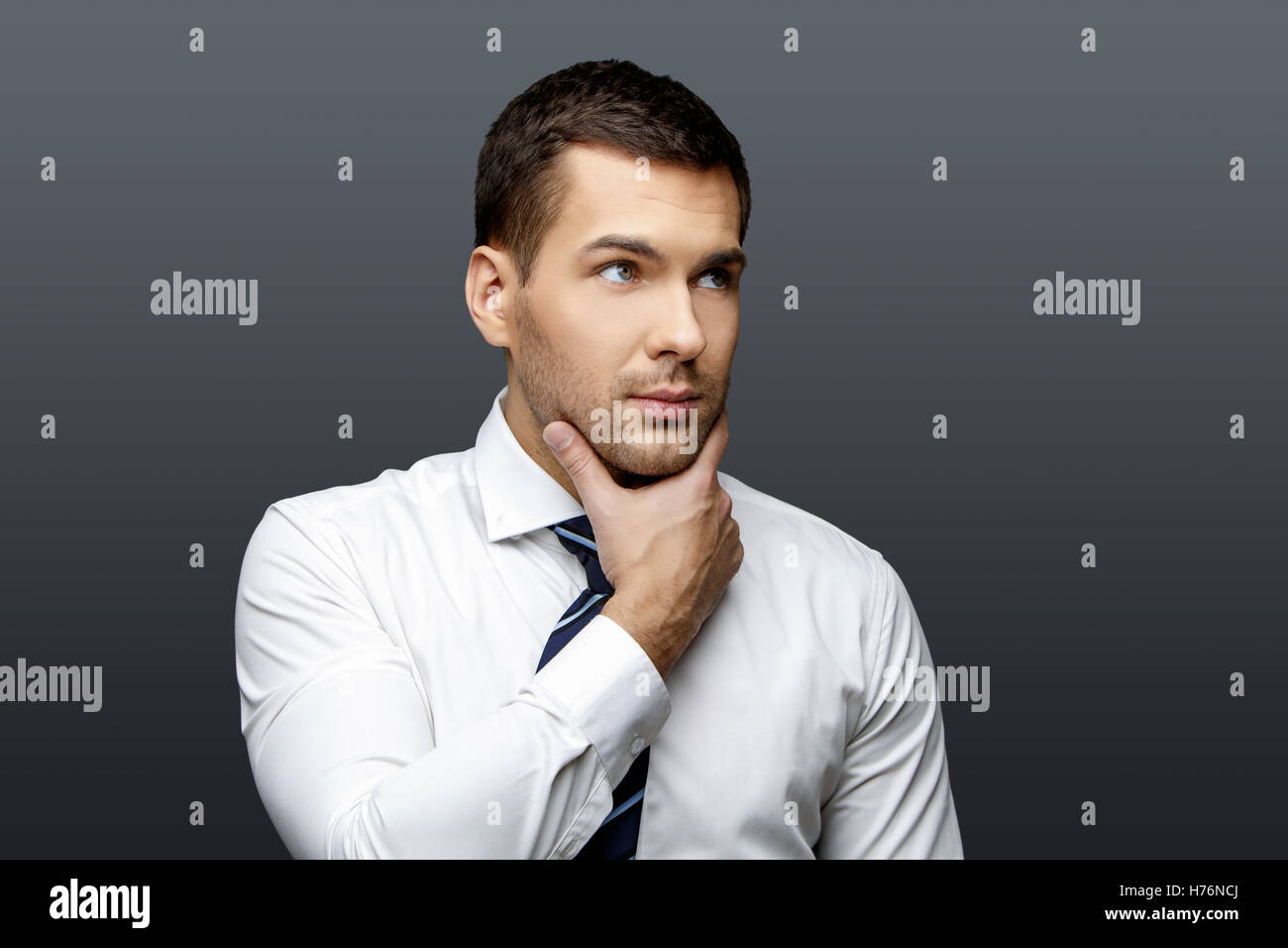 Handsome stylish businessman on grey background Stock Photo - Alamy