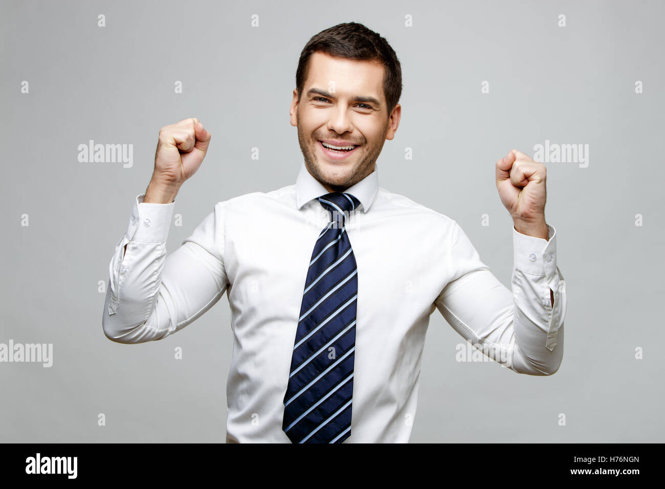 Handsome stylish businessman on grey background Stock Photo - Alamy