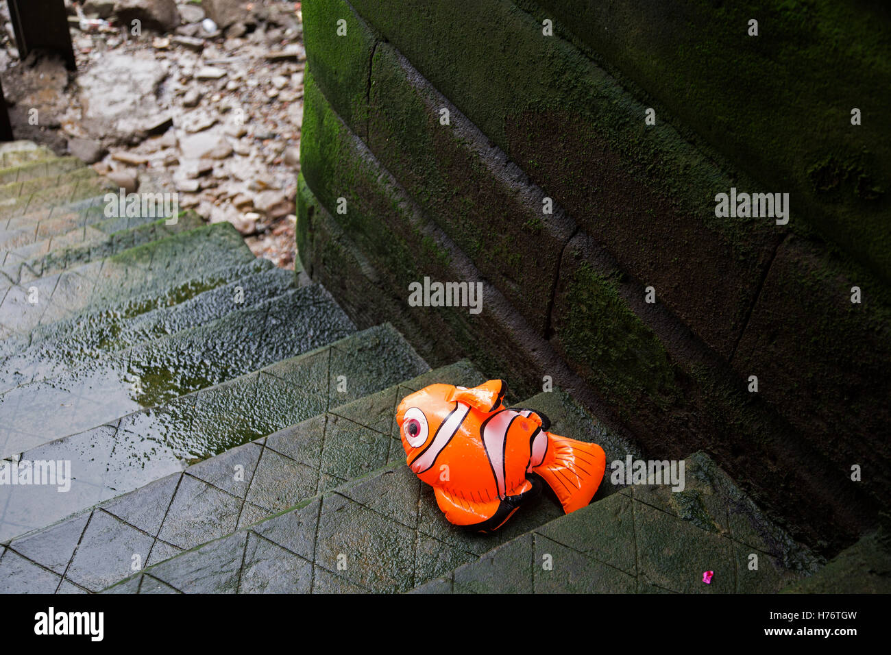 Inflatable Finding Nemo character washed up on some old steps leading down to the River Thames in London, England, United Kingdom. Finding Nemo is a 2003 American computer-animated comedy-drama adventure film produced by Pixar Animation Studios and released by Walt Disney Pictures. Stock Photo