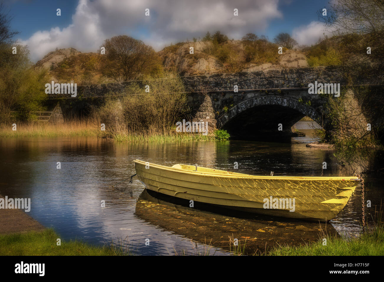 Bright yellow boat on Llyn Padarn in North Wales, UK Stock Photo