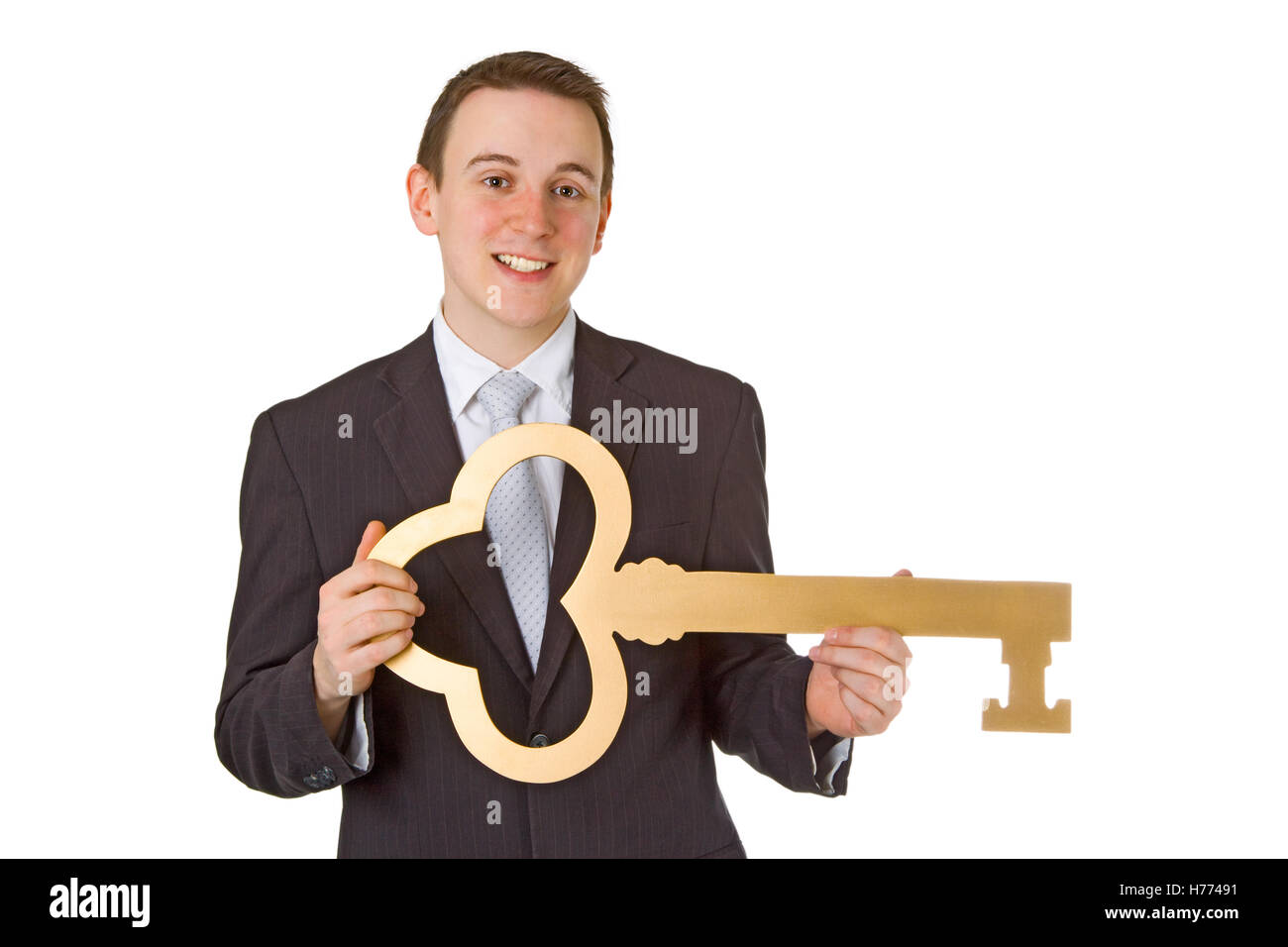 Young businessman with golden key isolated on white background Stock ...