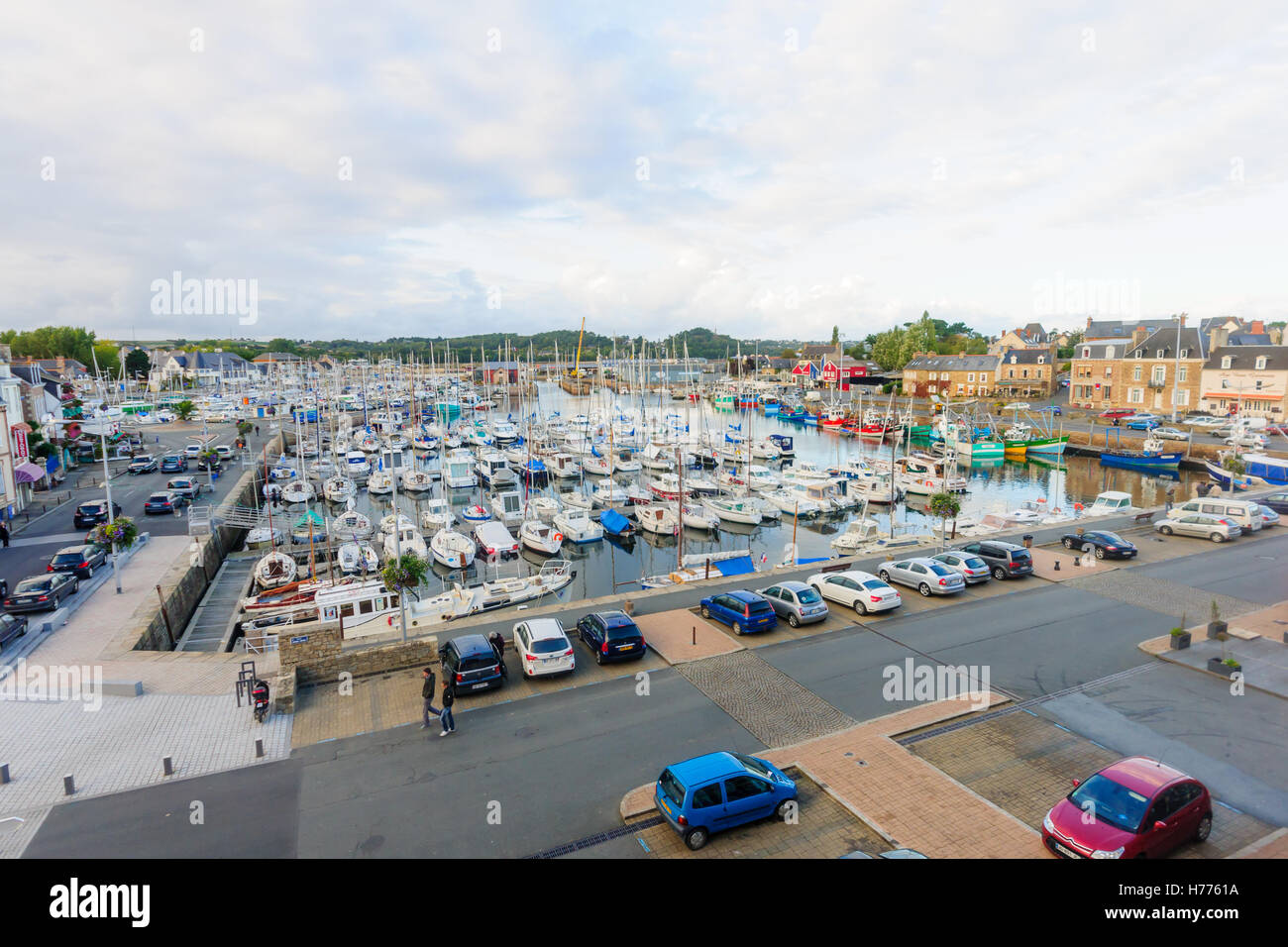 PAIMPOL, FRANCE - SEPTEMBER 26, 2012: Sunset view of the port, with local businesses, locals and visitors, in Paimpol, Brittany, Stock Photo