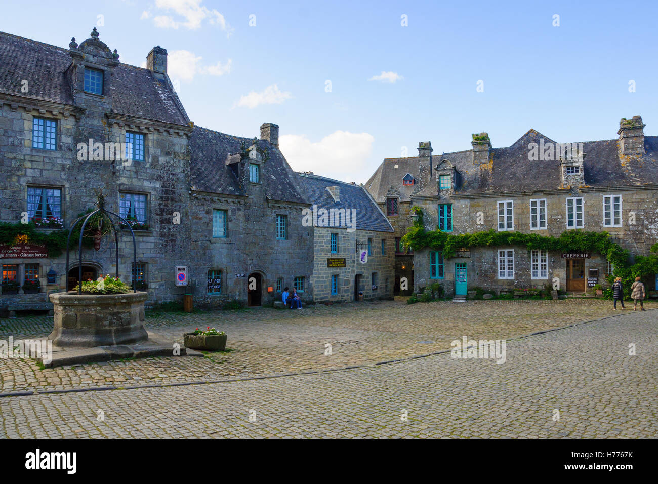 LOCRONAN, FRANCE - SEPTEMBER 29, 2012: Typical buildings, with locals and visitors, in Locronan, Brittany, France Stock Photo