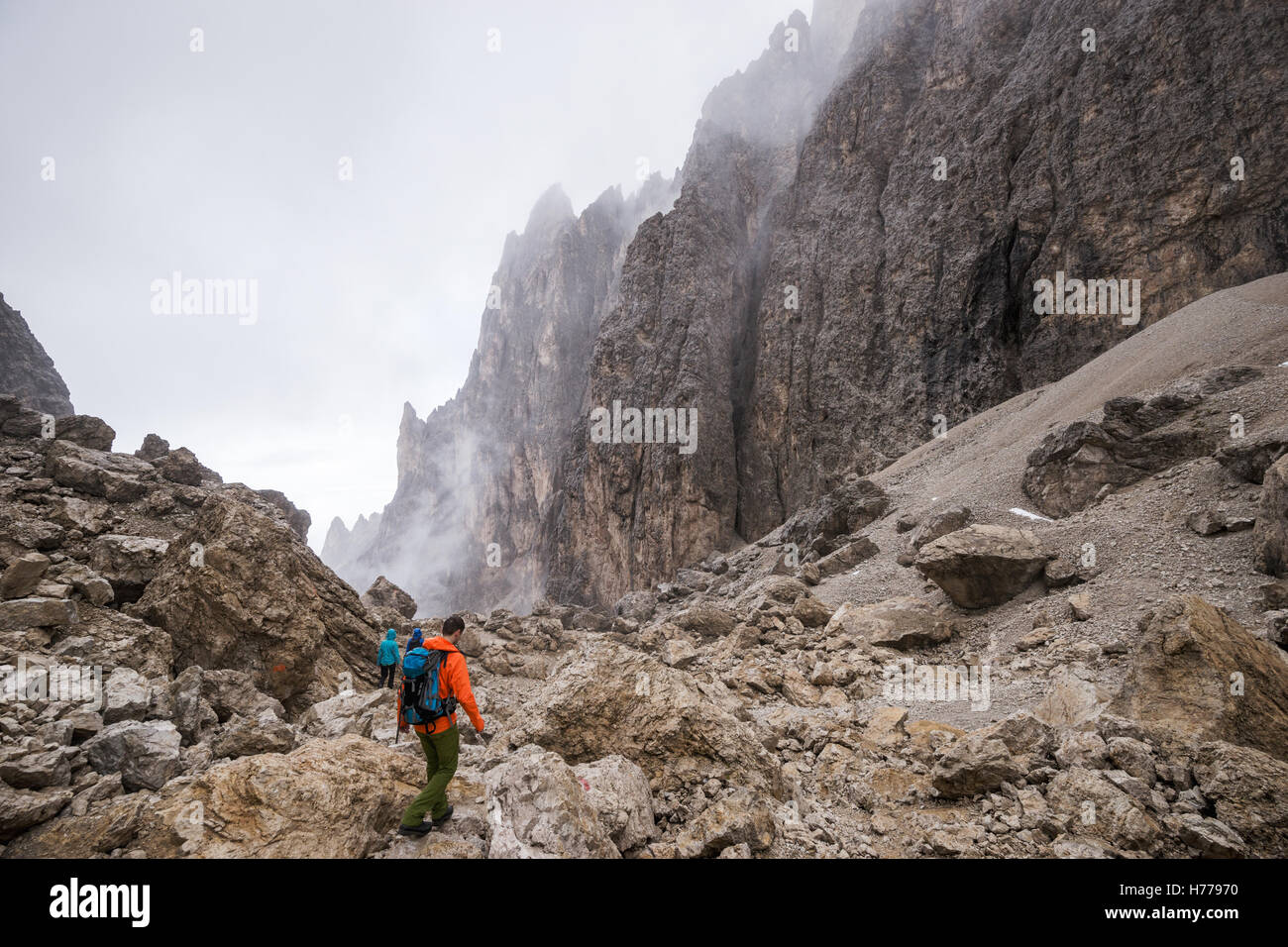 Three people hiking in the Dolomites, Val Gardena, South Tyrol, Italy Stock Photo