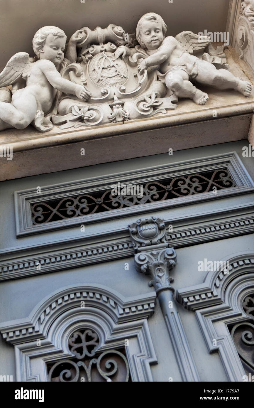 Stylish wooden door and statue on a French mansion facade Stock Photo ...