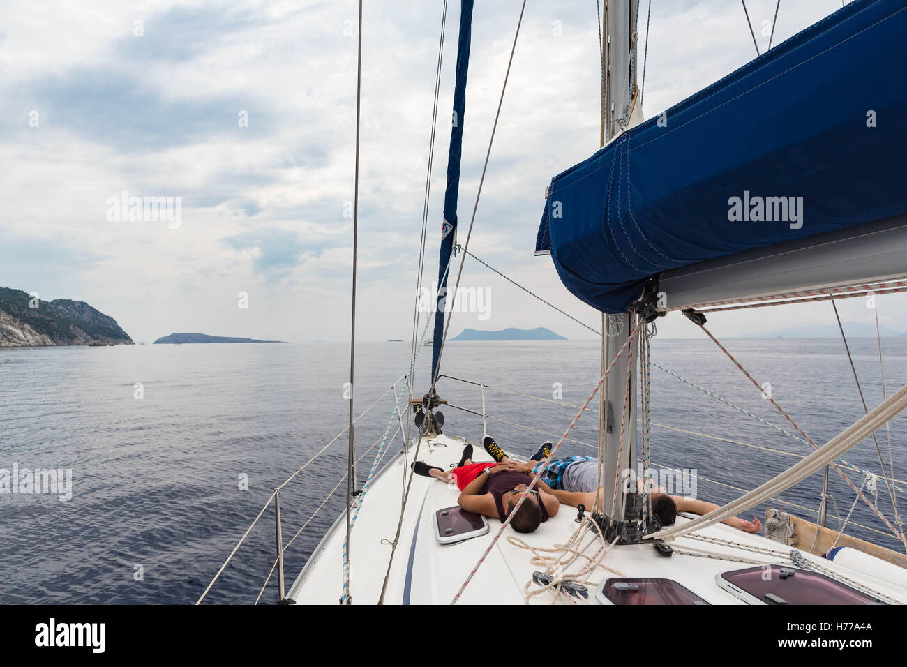Two men lying on a yacht, Lefkada, Greece Stock Photo
