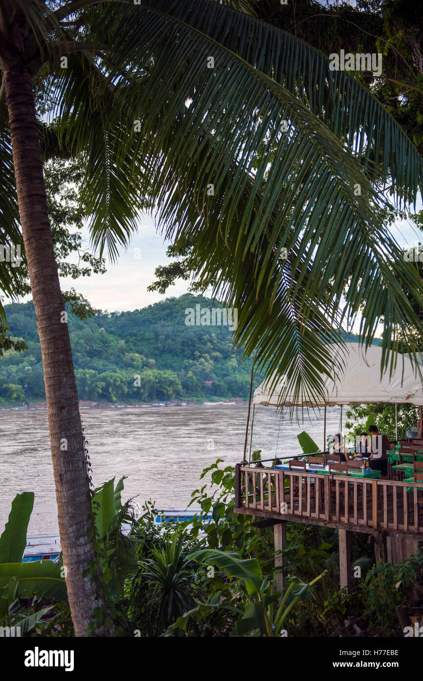 A bar jutting out over the Mekong River in central Luang Prabang. Stock Photo