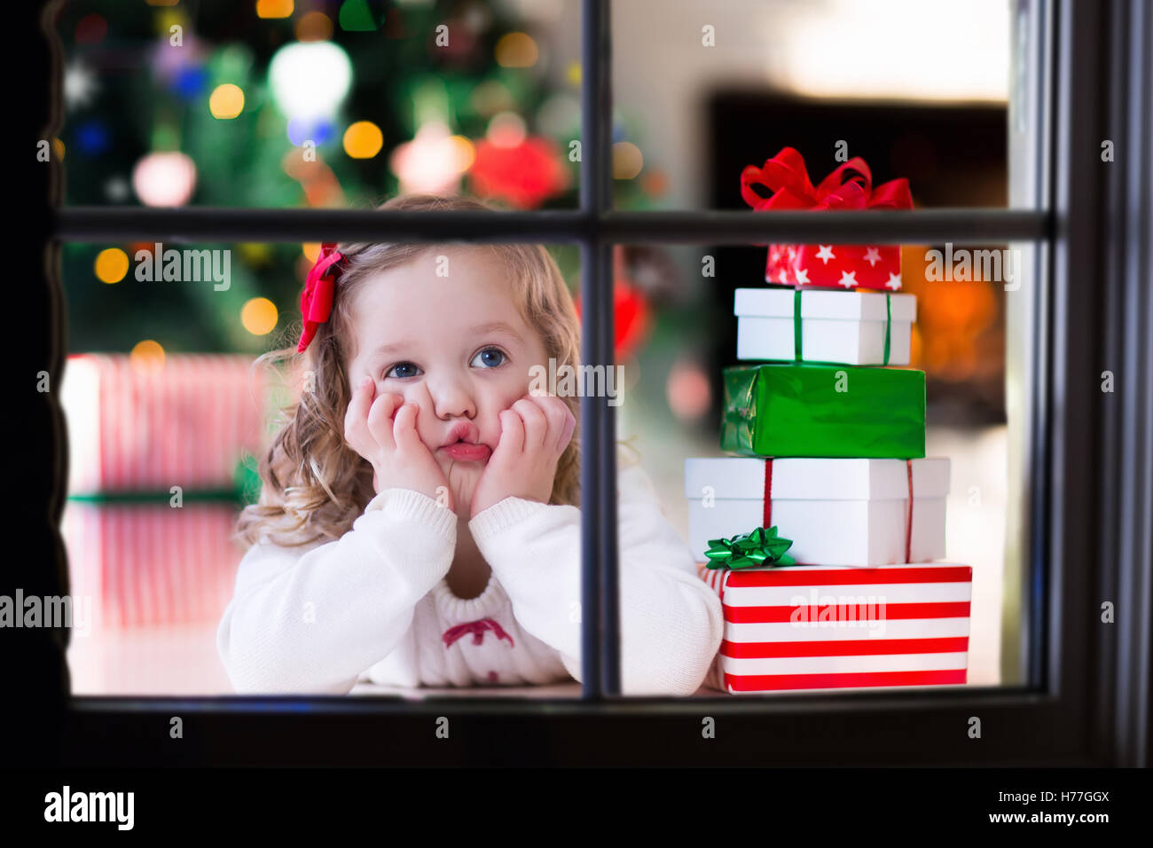 Little girl waiting for Santa at home window on Christmas eve. Kids ...