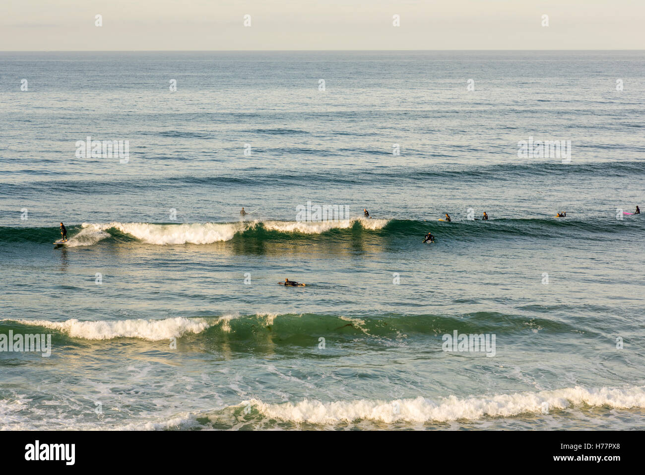 Group of surfers surfing off of Tourmaline Beach. San Diego, California, USA. Stock Photo