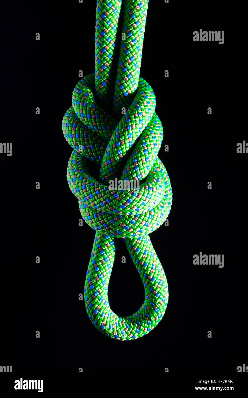 Figure eight knot in a climbing rope with a black background Stock