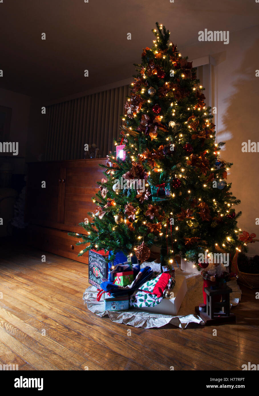 Christmas tree with lights in a dark room Stock Photo - Alamy