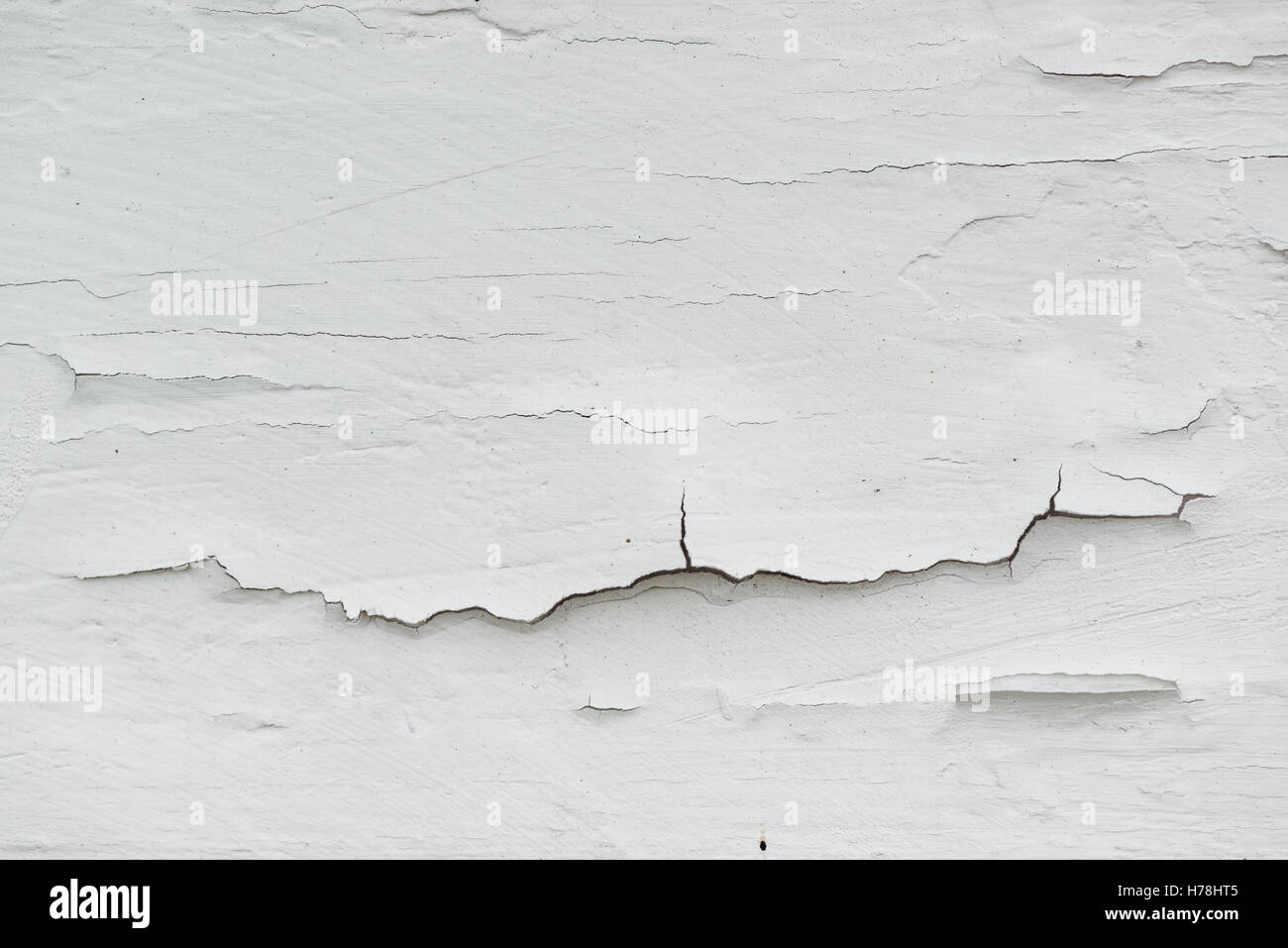 Cracked white paint on plank surface, abstract wooden background Stock Photo