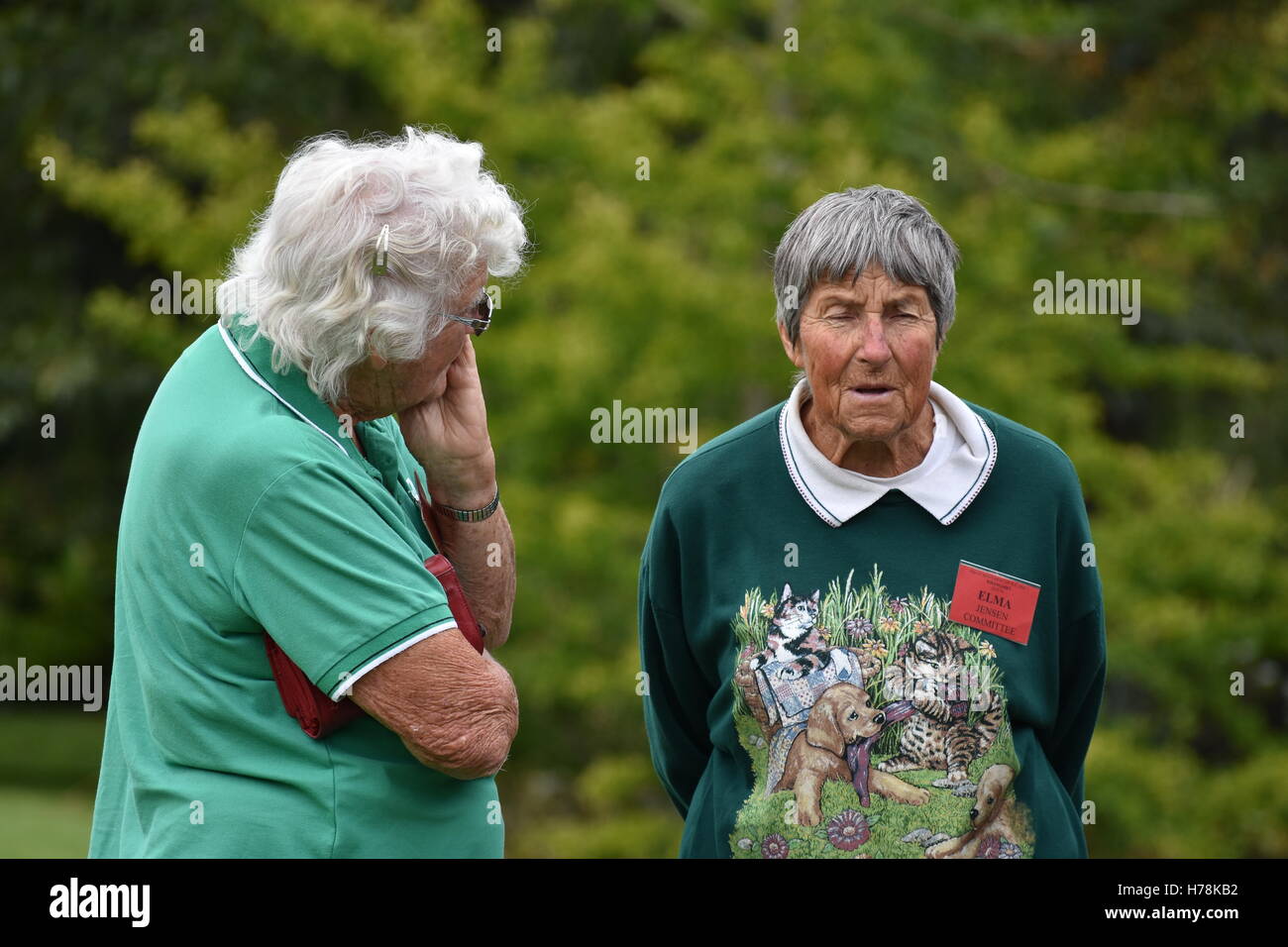Senior ladies talking outside in a park. Stock Photo