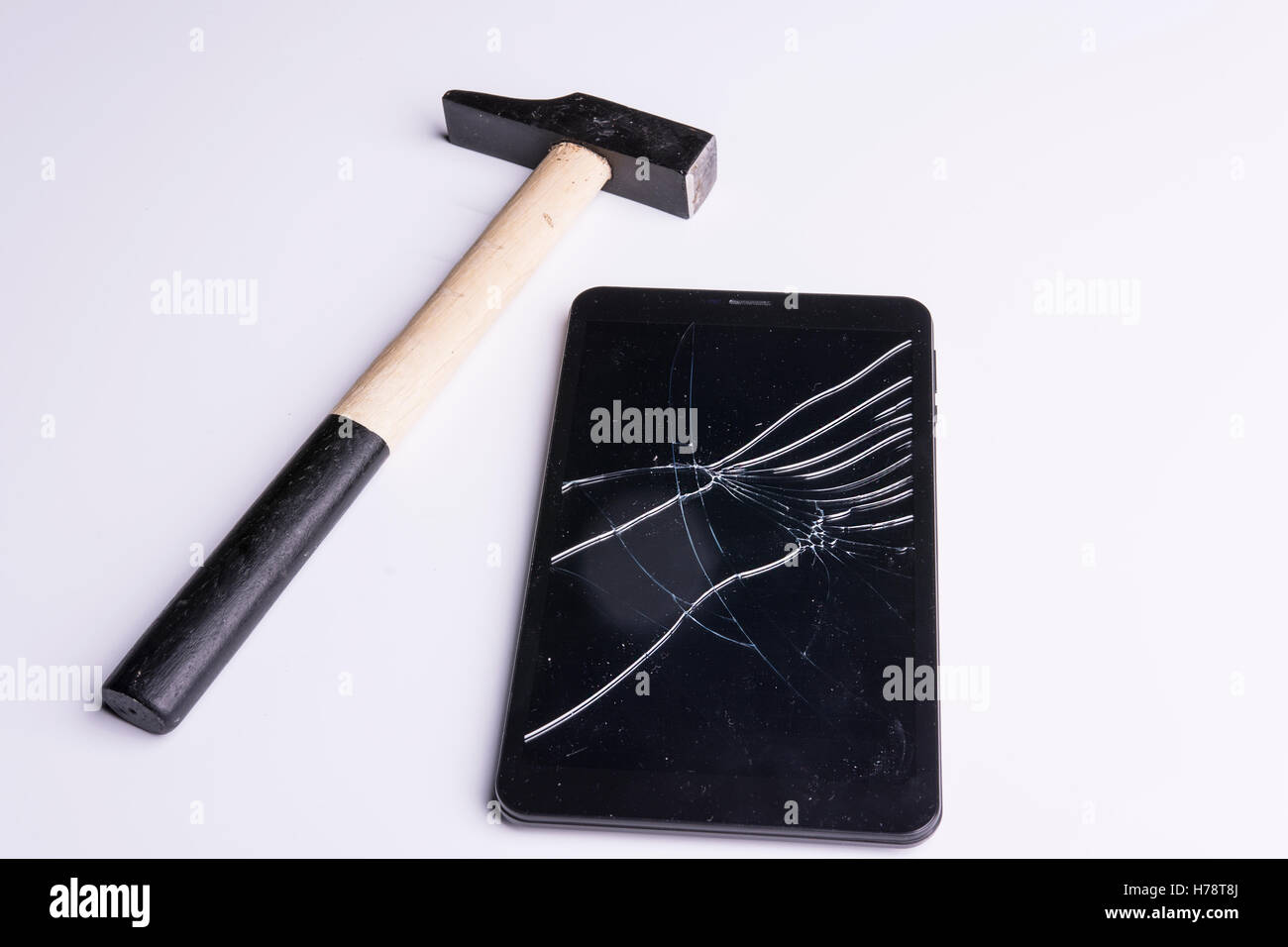 a tablet broken with the hammer Stock Photo