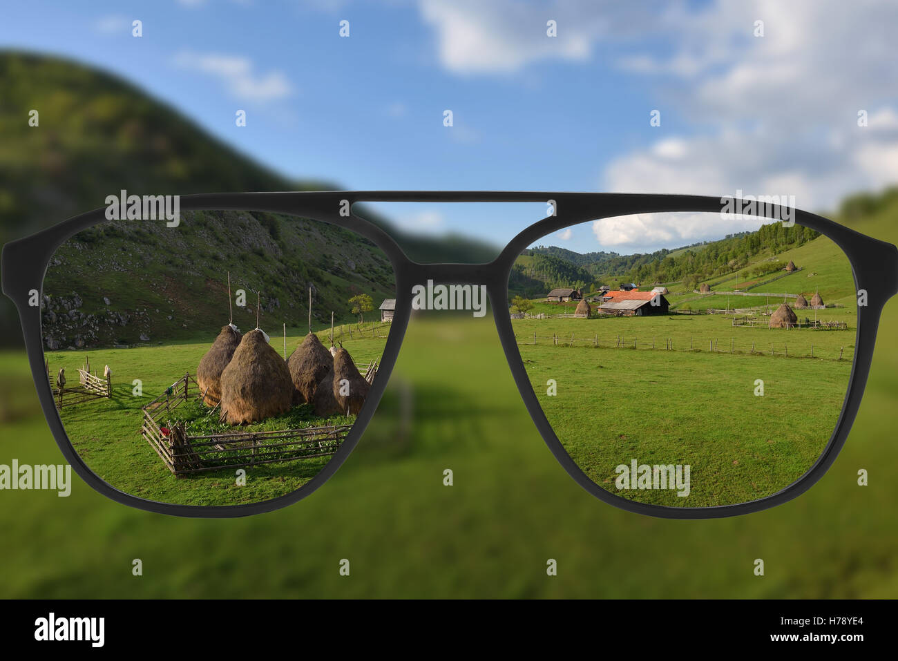 Clear image in glasses against blurry landscape Stock Photo Alamy
