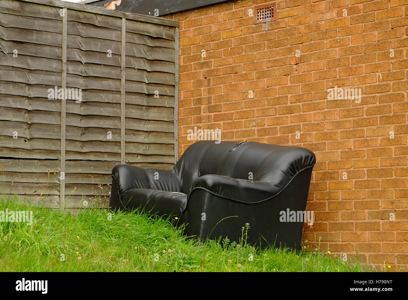 old sofa dumped in a garden Stock Photo Alamy