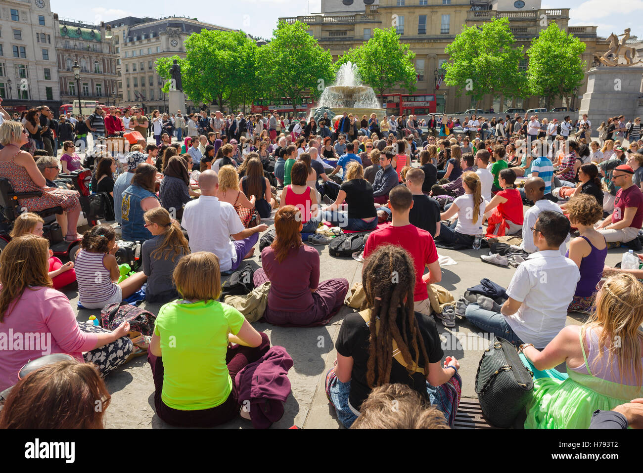Meditation city, rear view of participants in a mass group meditation in Trafalgar Square, London, UK. Stock Photo