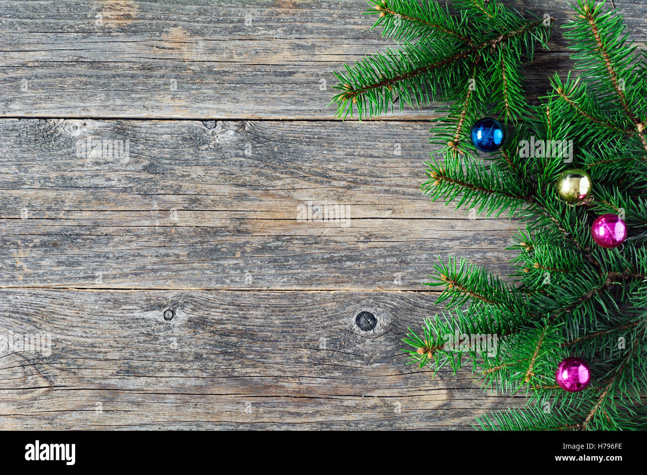 Christmas background: Wooden background with Christmas fir tree and colorful balls. Copy space for text. New year,Christmas card Stock Photo