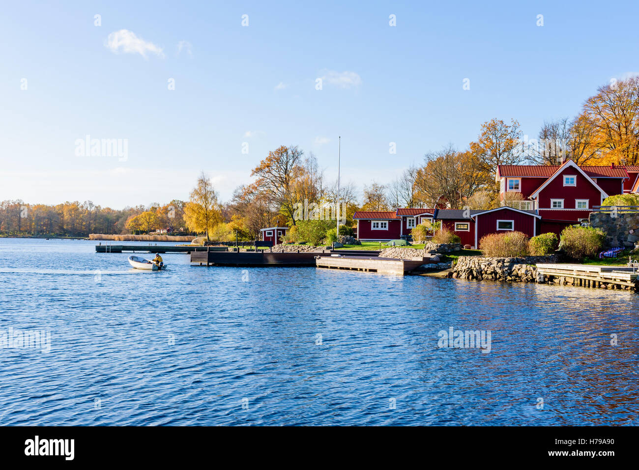 Bokevik, Sweden - October 29, 2016: Environmental documentary of coastal lifestyle. Man in small motorboat just outside the priv Stock Photo