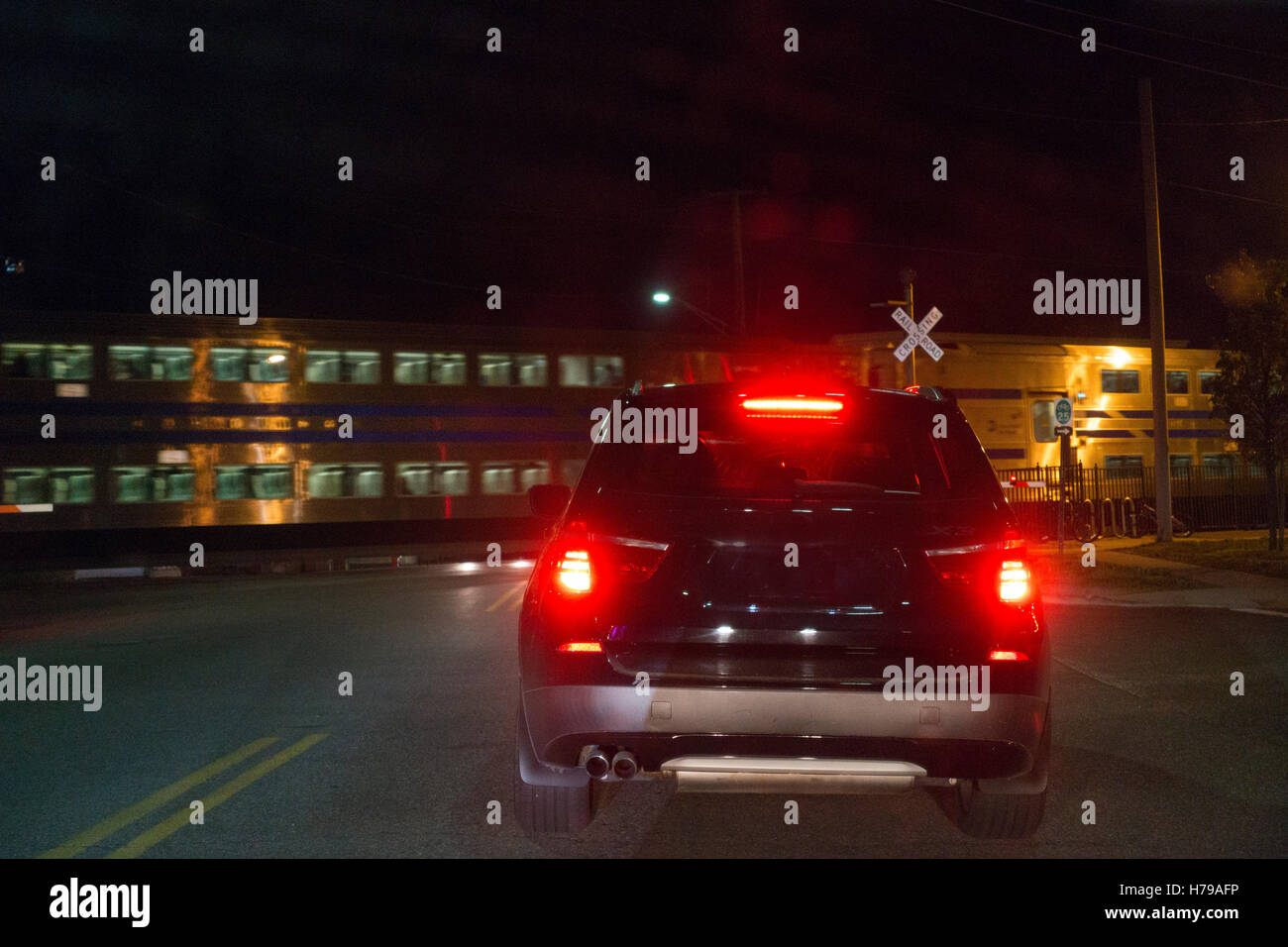 commuter train passing in front of a car Long Island NY Stock Photo Alamy