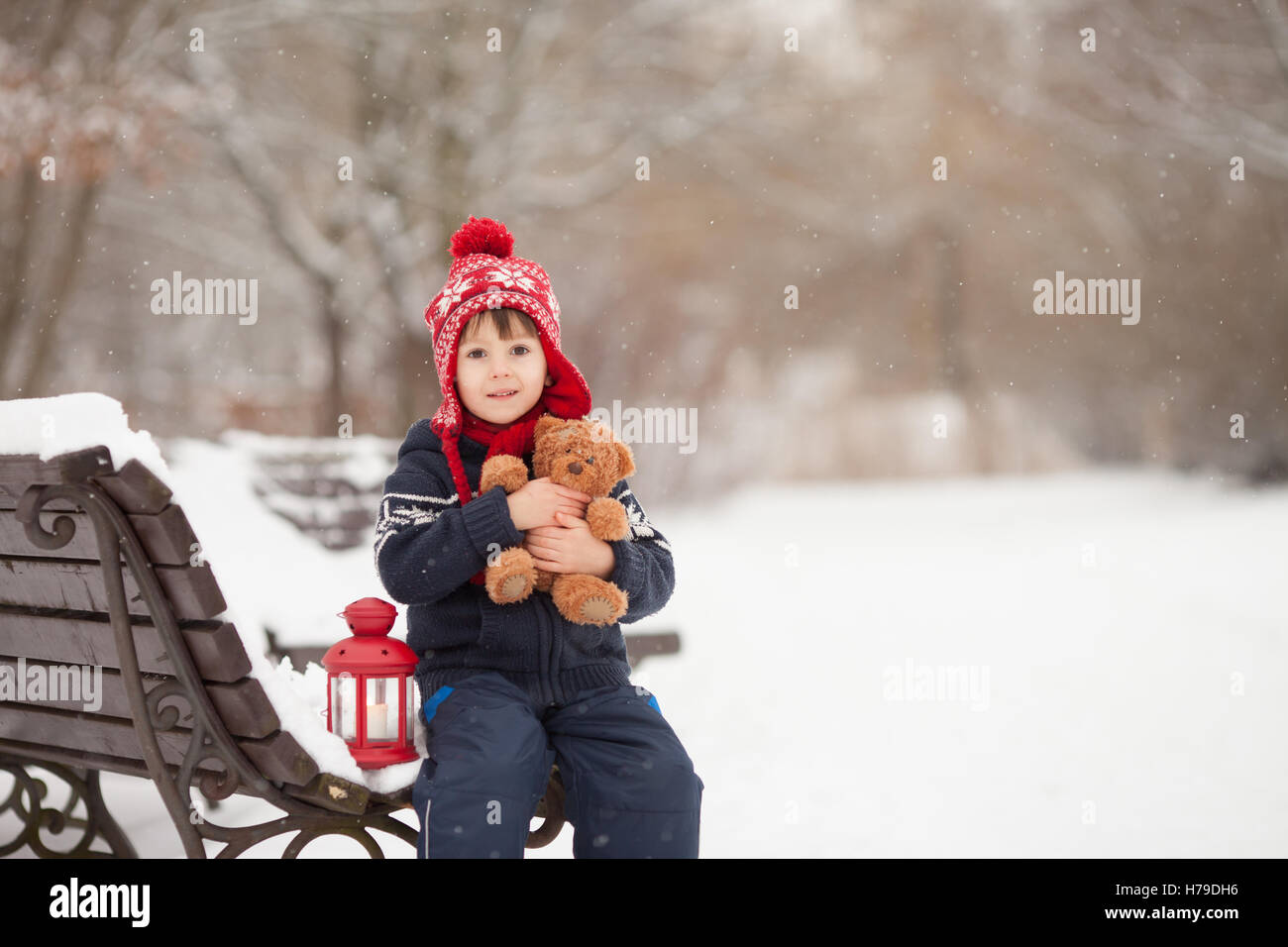 Cute little caucasian boy with teddy bear and red lantern, playing in ...