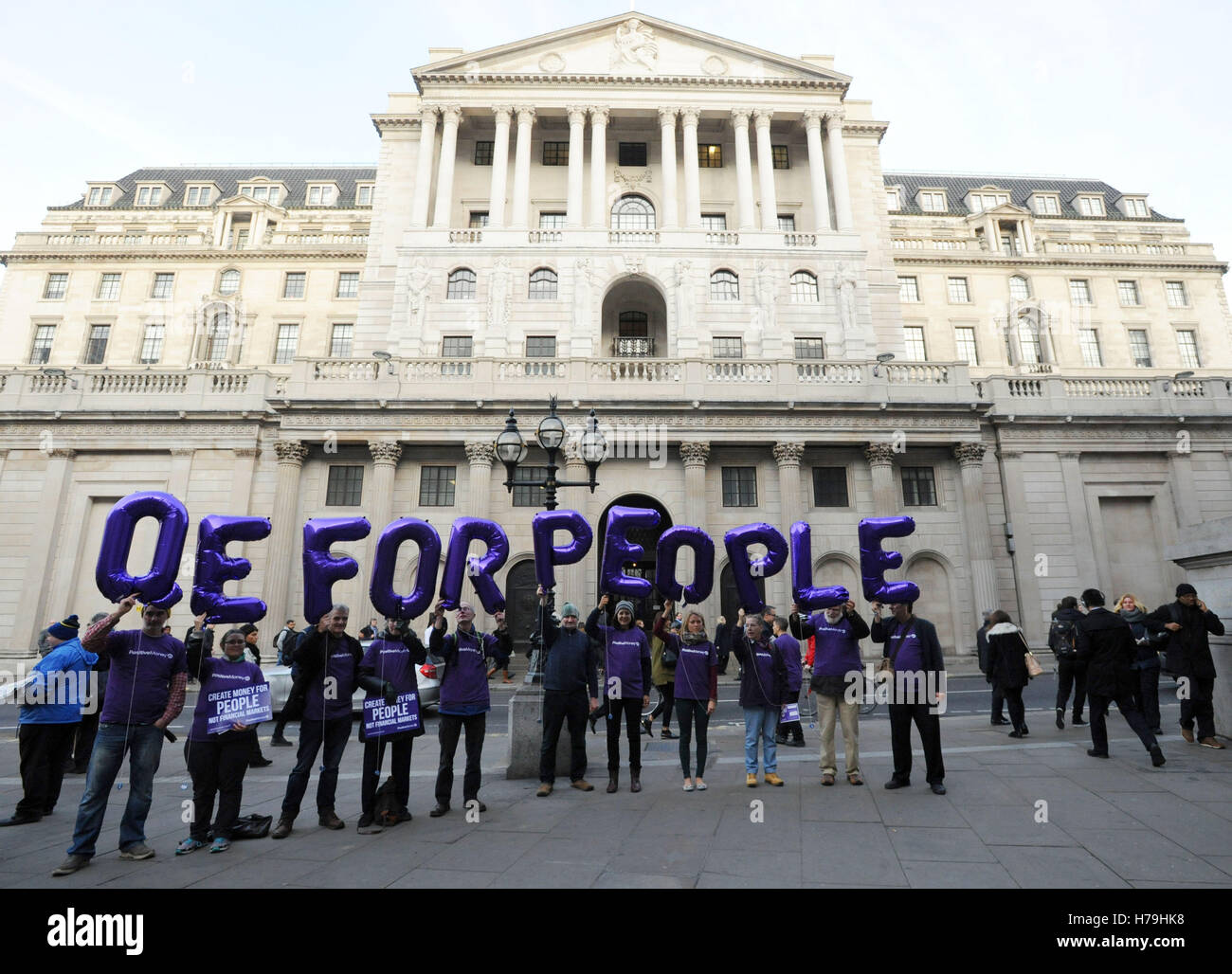 Campaigners hold up helium balloons outside the Bank of England, London, calling on the bank to replace its quantitative easing programme with QE for People, highlighting the fact that foreign-owned corporations are benefiting from the Bank's purchases of corporate bonds. Stock Photo