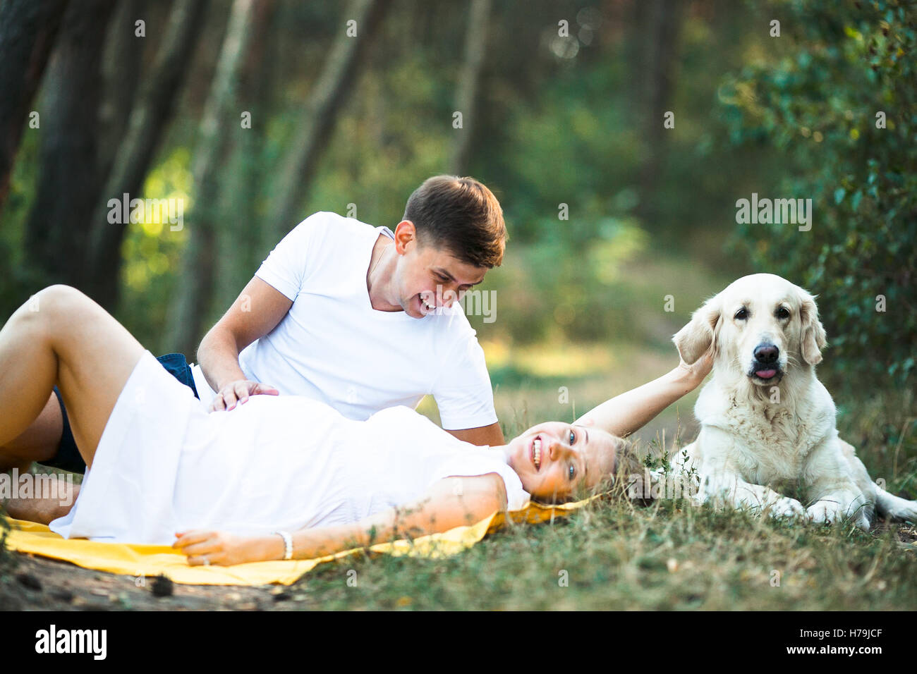 pregnant woman with husband lying in the park Stock Photo - Alamy