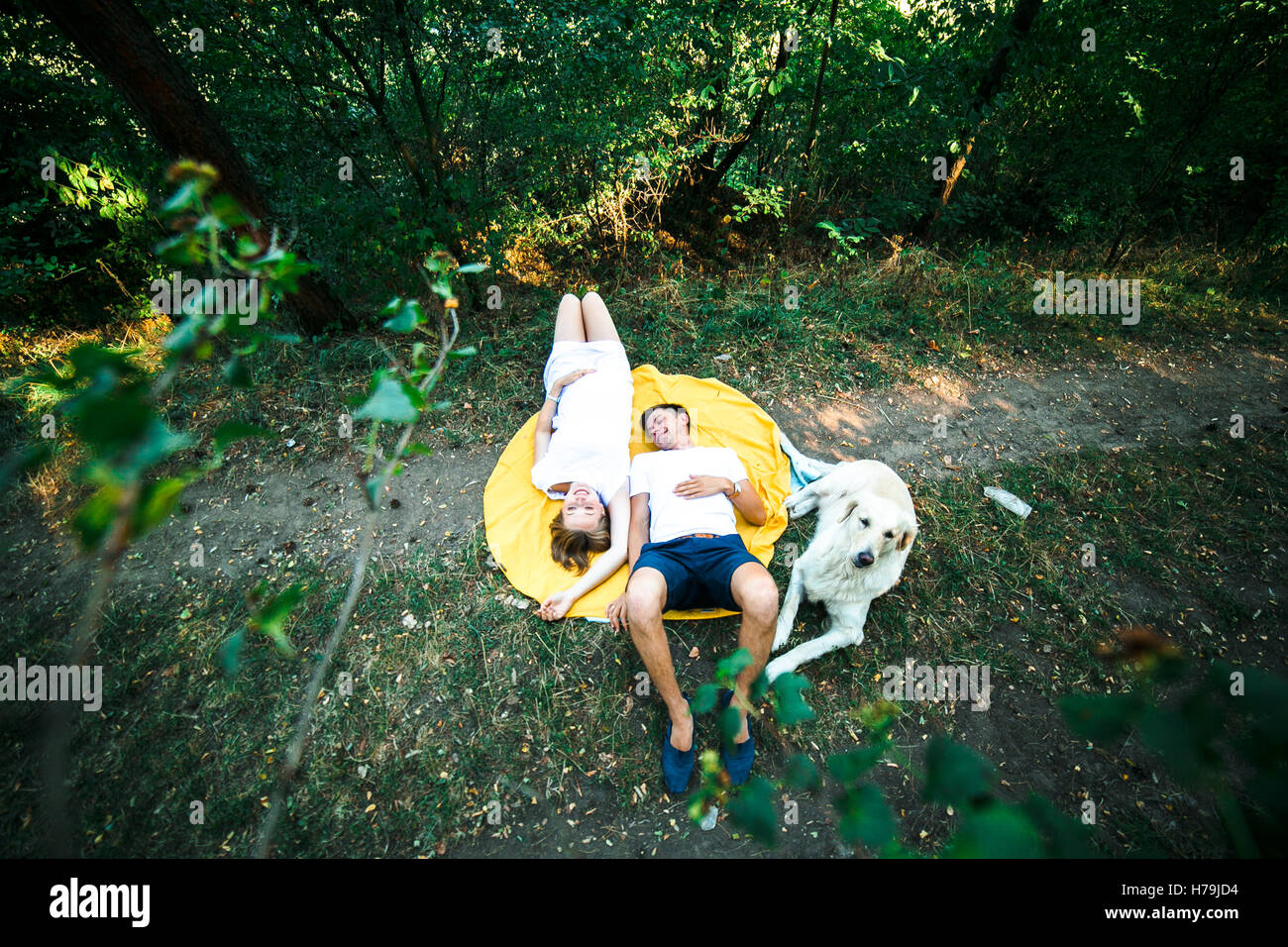 pregnant woman with husband lying in the park Stock Photo - Alamy