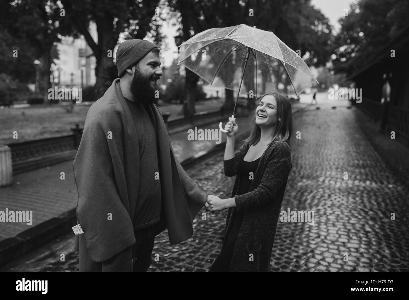 guy and girl under an umbrella Stock Photo Alamy