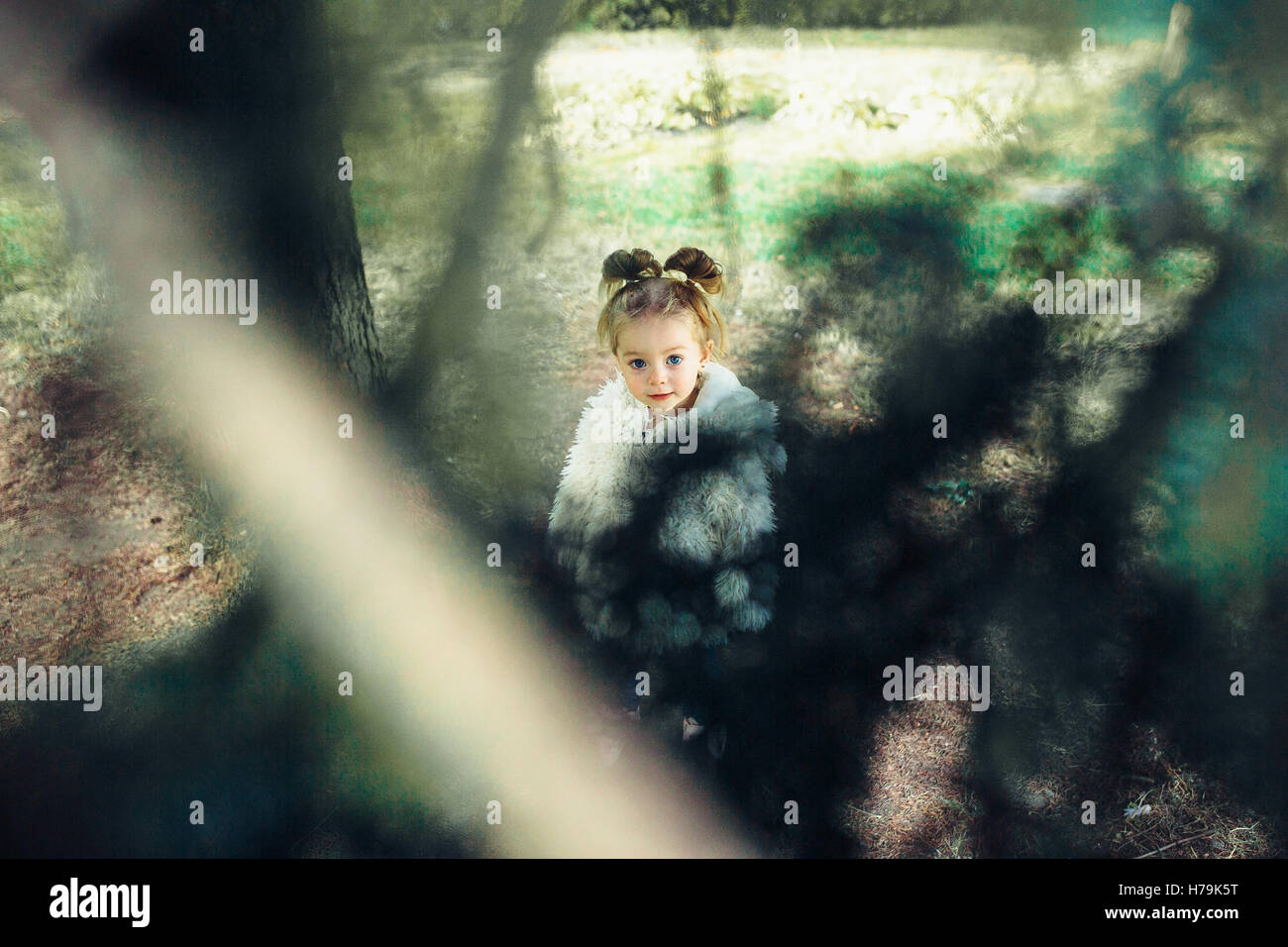 Cute little girl is playing outdoors Stock Photo - Alamy