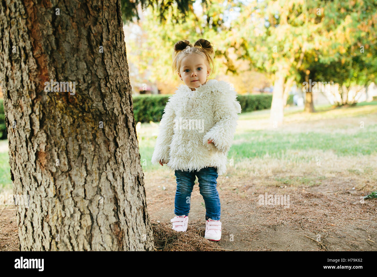 Cute little girl is playing outdoors Stock Photo - Alamy