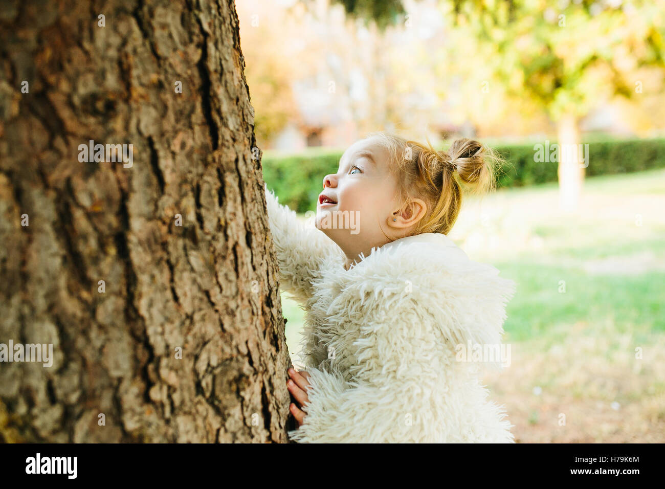 Cute little girl is playing outdoors Stock Photo - Alamy