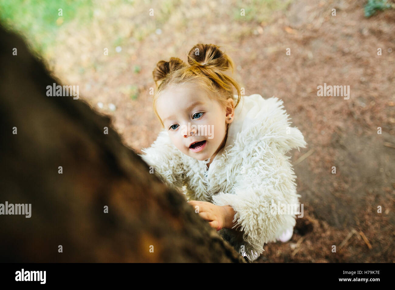 Cute little girl is playing outdoors Stock Photo - Alamy