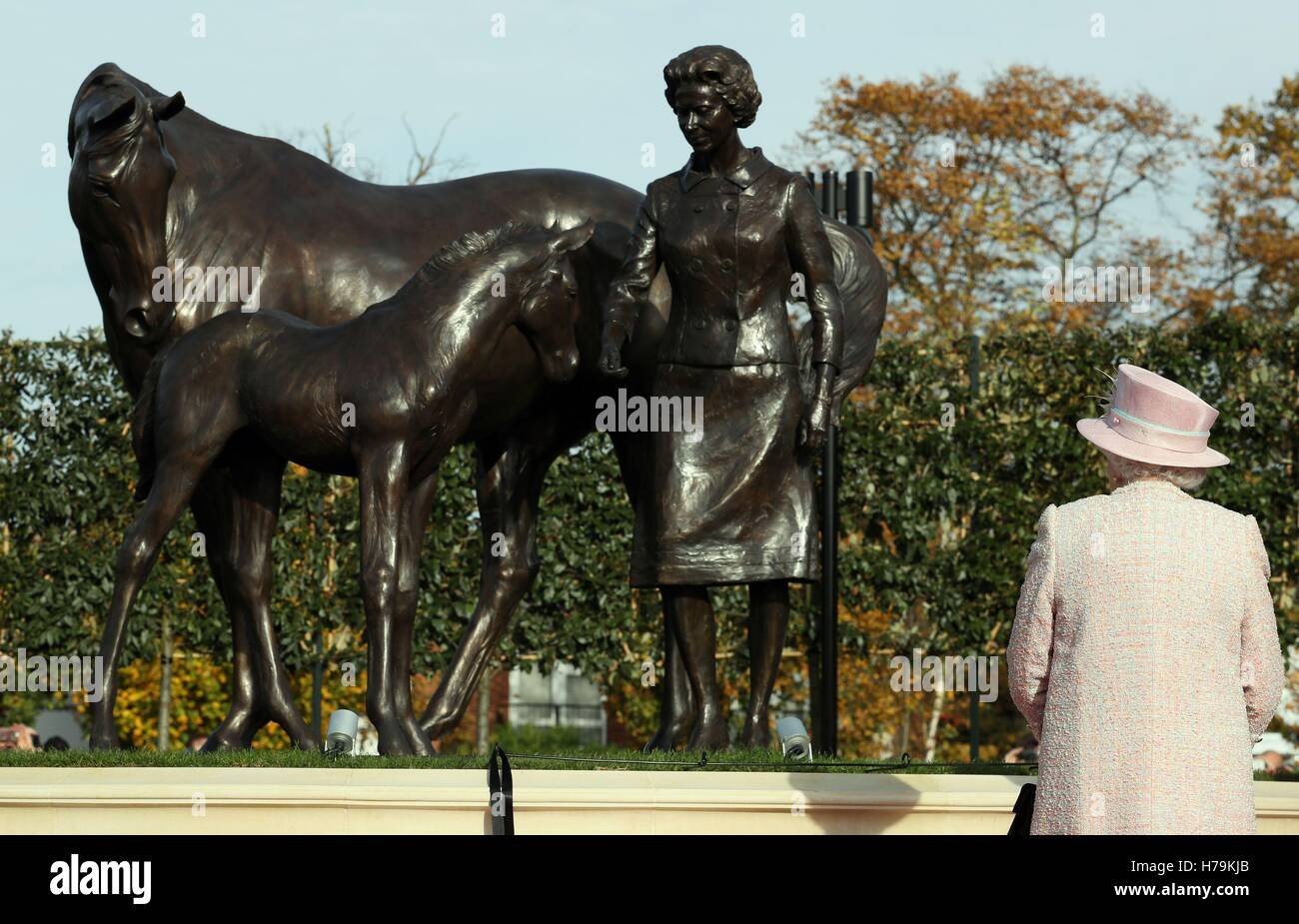 Queen Elizabeth II at Newmarket Racecourse, after she unveiled a statue of herself with a foal and a mare as a gift in the year of her 90th birthday, during a visit to the town often referred to as the headquarters of British racing. Stock Photo