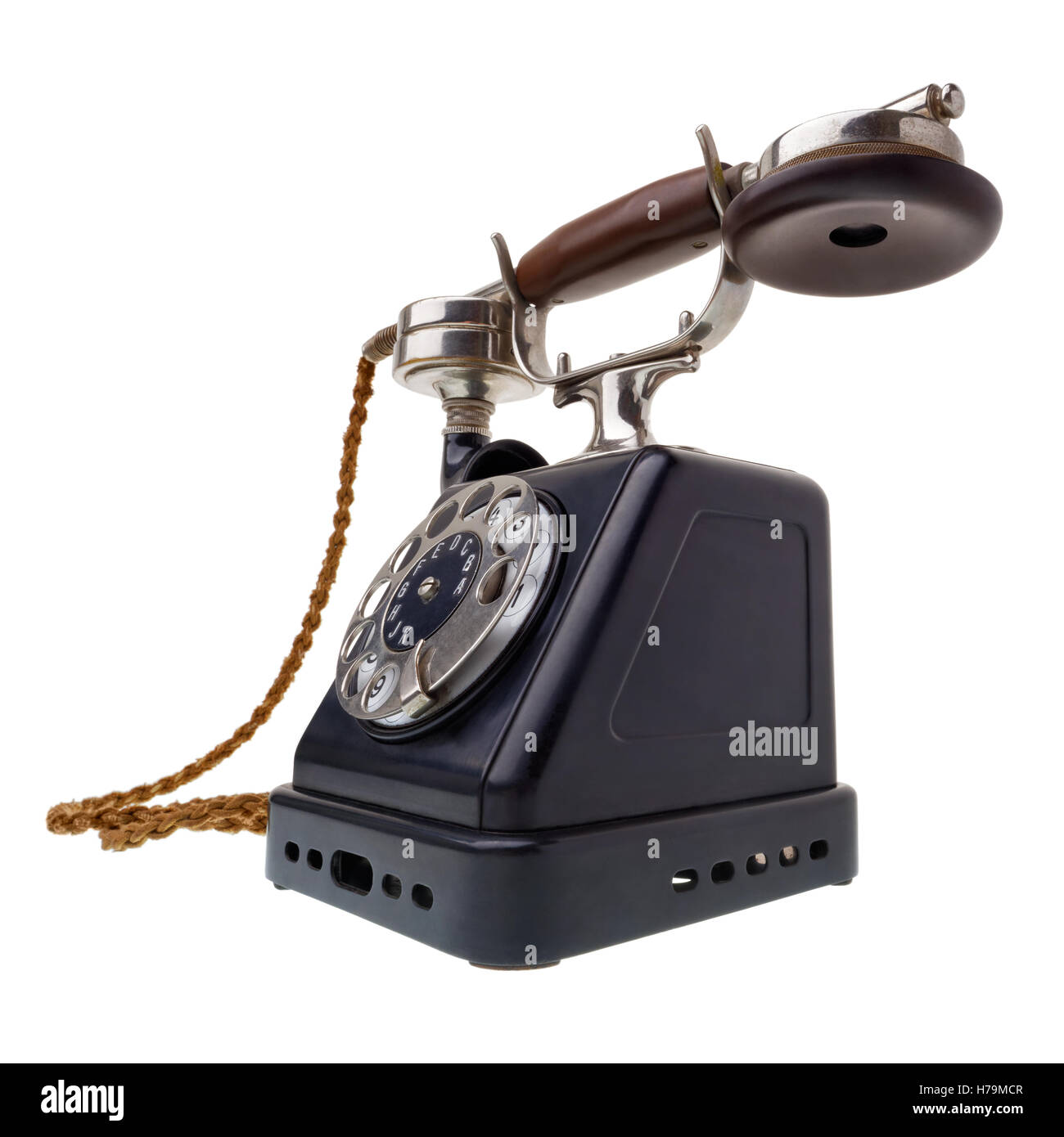 Isolated objects: one antique black telephone, very old and aged, isolated on white background Stock Photo