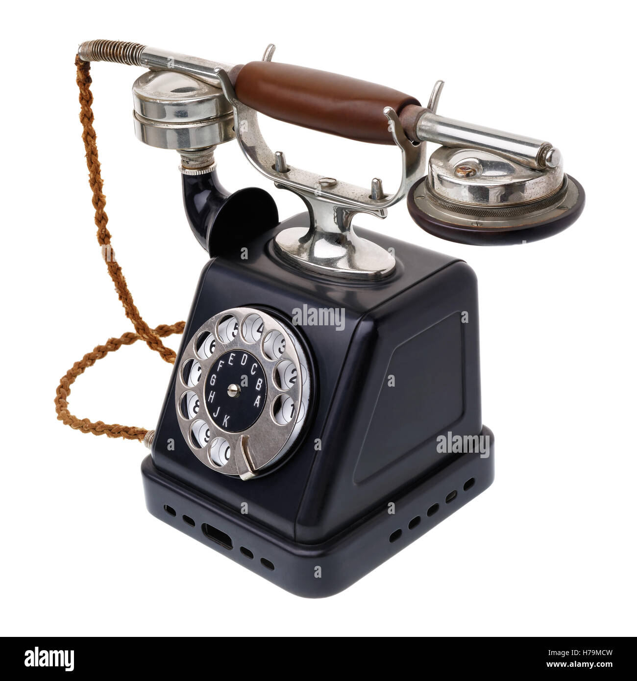 Isolated objects: one antique black telephone, very old and aged, isolated on white background Stock Photo