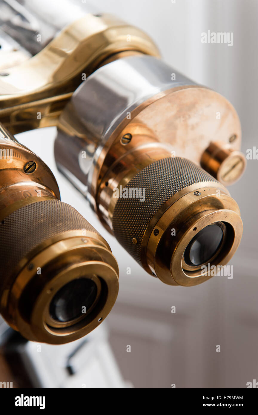 Lens and adjustment guage on pair of vintage brass binoculars Stock Photo