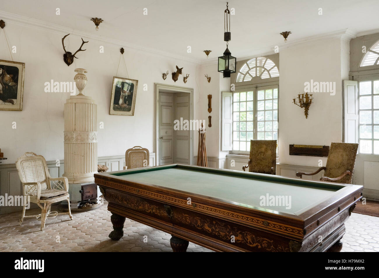 Billiards table with hunting trophies in games room with terracotta