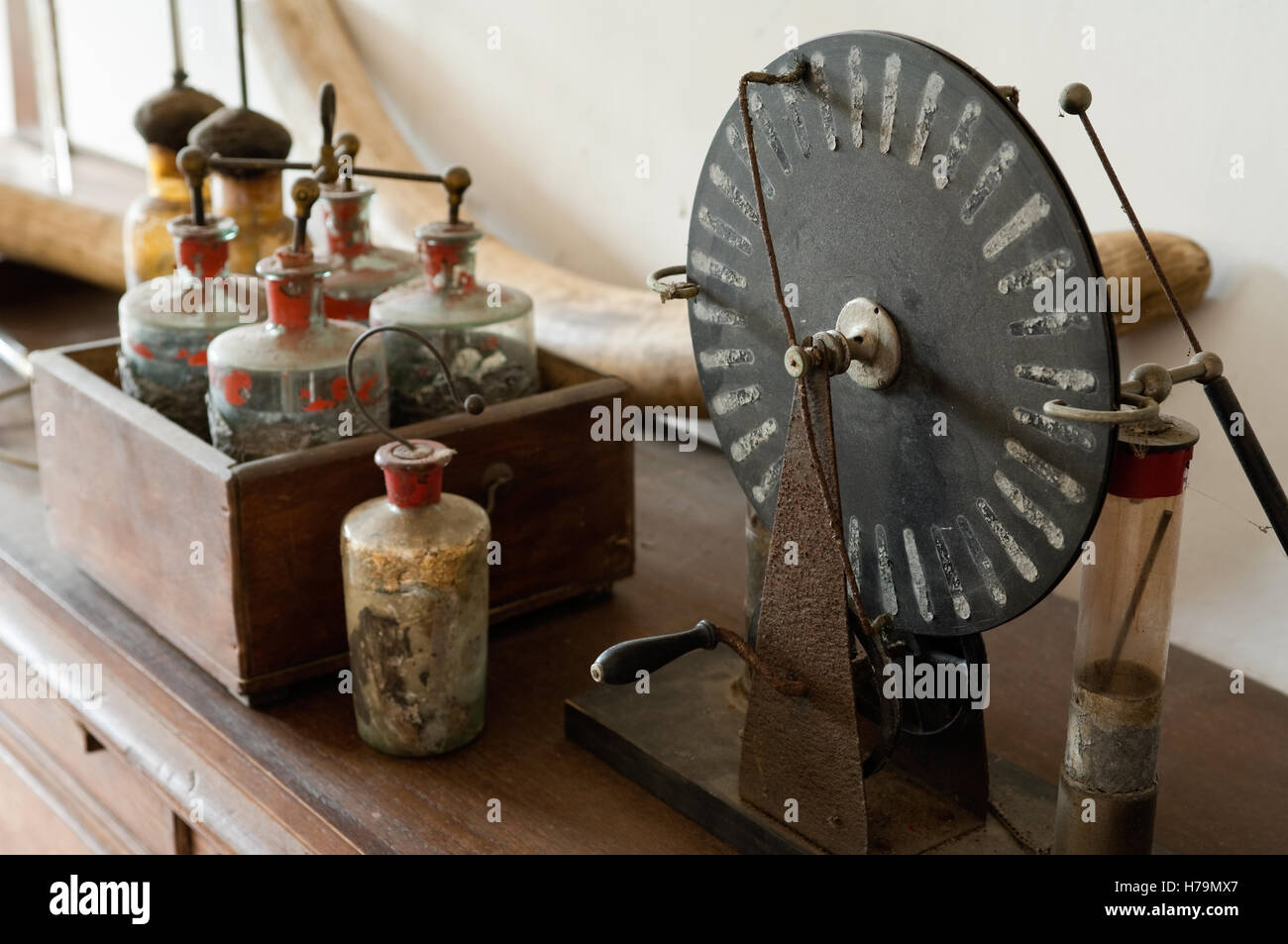 Measurement wheel and vintage bottles in 18th century Chateau de Cussigny, Cote d'Or, Bourgogne, France Stock Photo