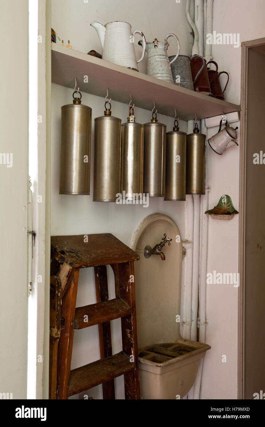 Vintage flasks hang on shelf with wooden step ladder in 18th century Chateau de Cussigny, Cote d'Or, Bourgogne, France Stock Photo