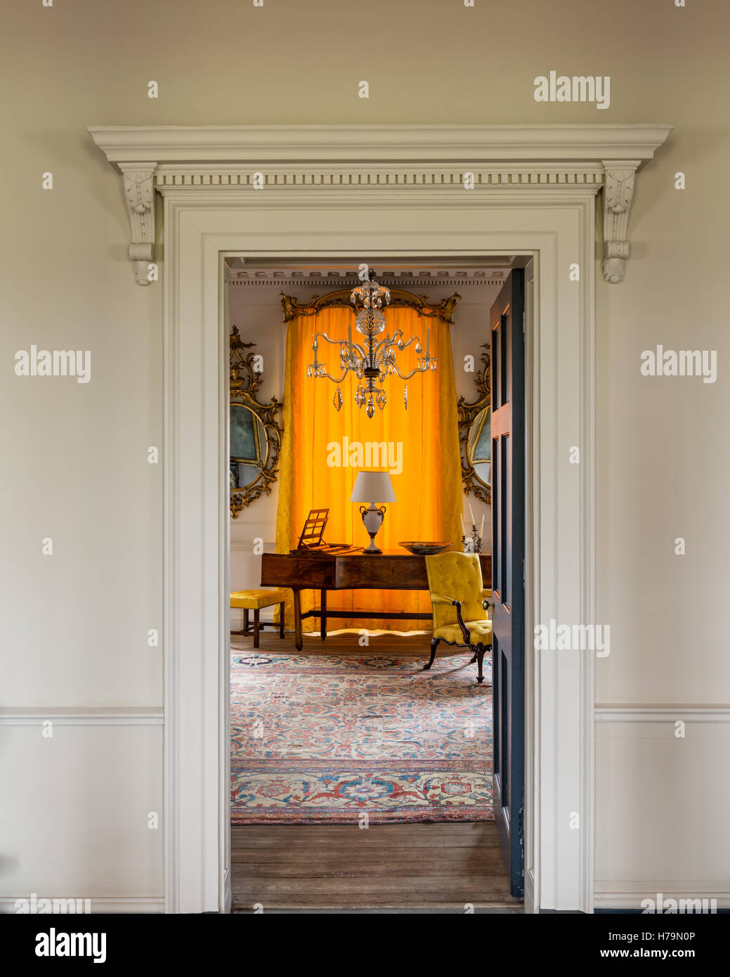 Yellow curtains and piano in 18th century Dumfries house, Ayrshire, Scotland Stock Photo