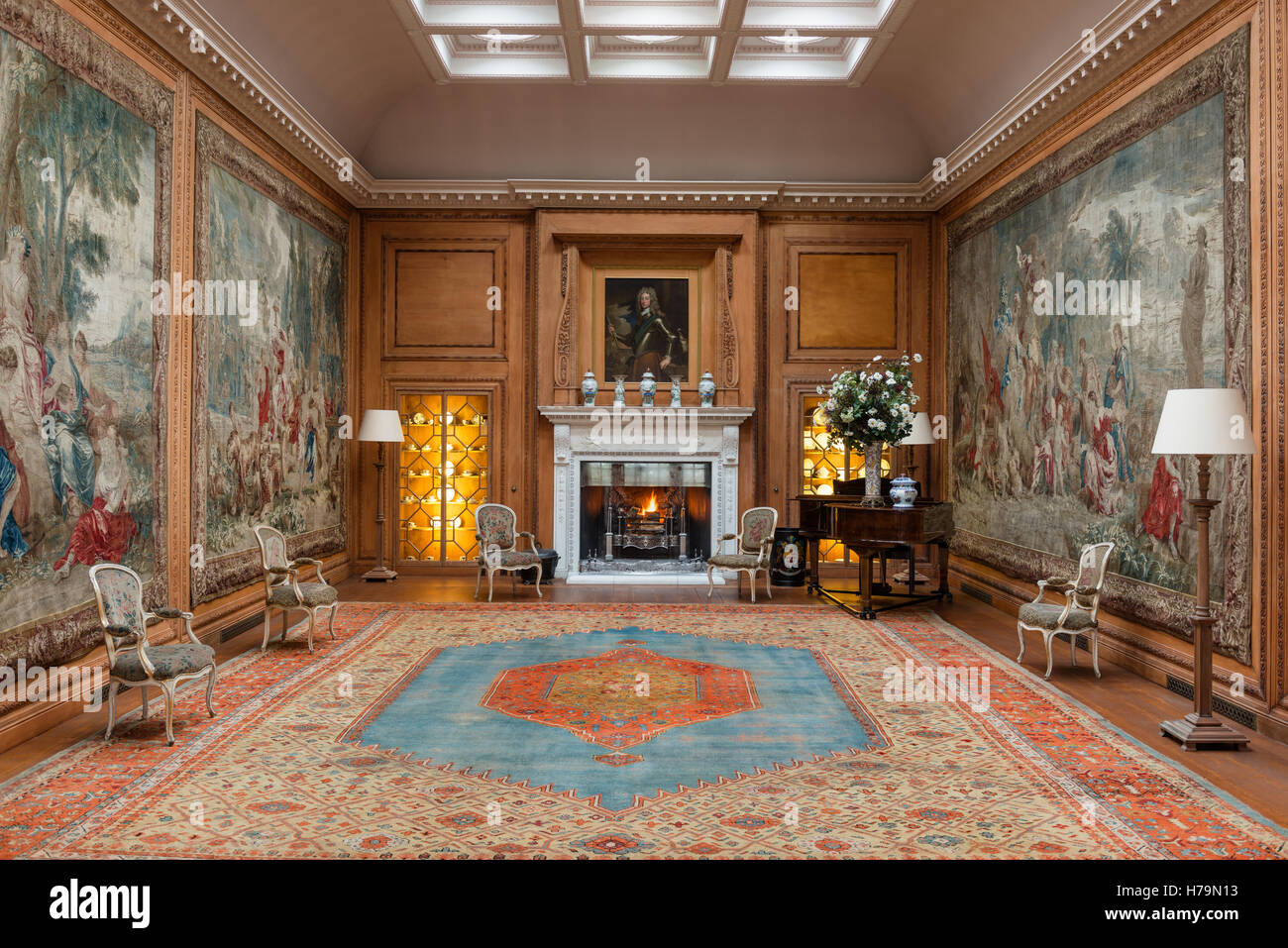 Lit fire and tapestry in 18th century Dumfries house, Ayrshire, Scotland Stock Photo
