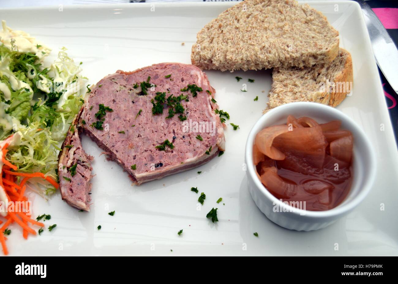 game terrine slice with confit of onions and bread Stock Photo Alamy