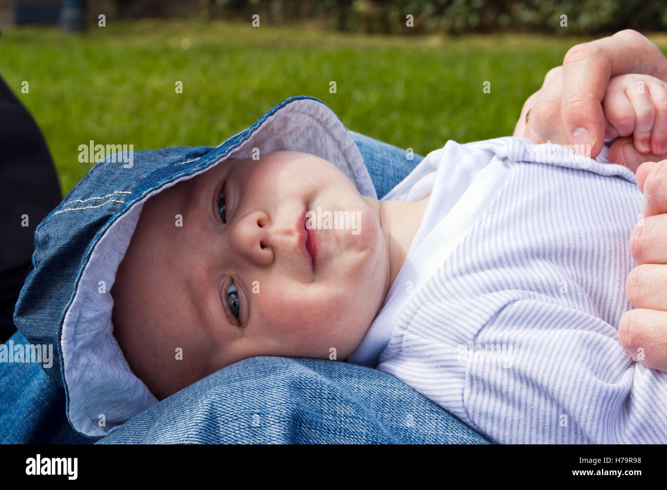Baby boy dribbling and wearing a sun hat Stock Photo
