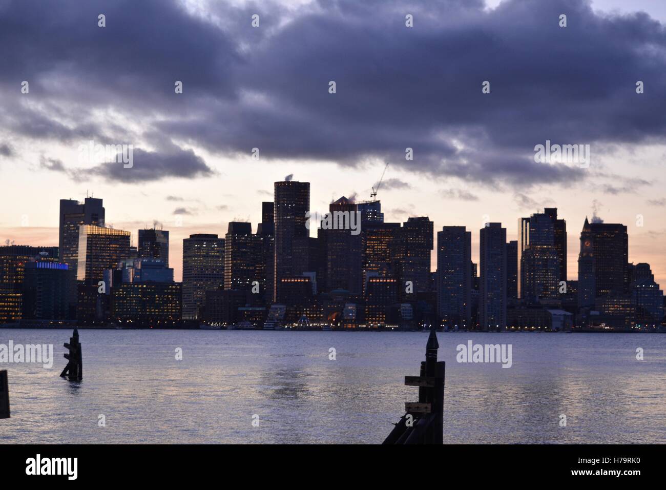 The downtown Boston skyline at sunset, seen from across Boston Harbor. Stock Photo
